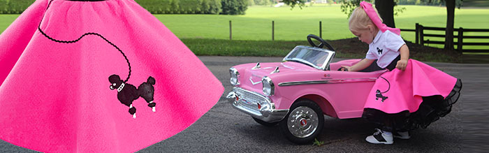 toddler playing with replica 50's car wearing a pink poodle skirt